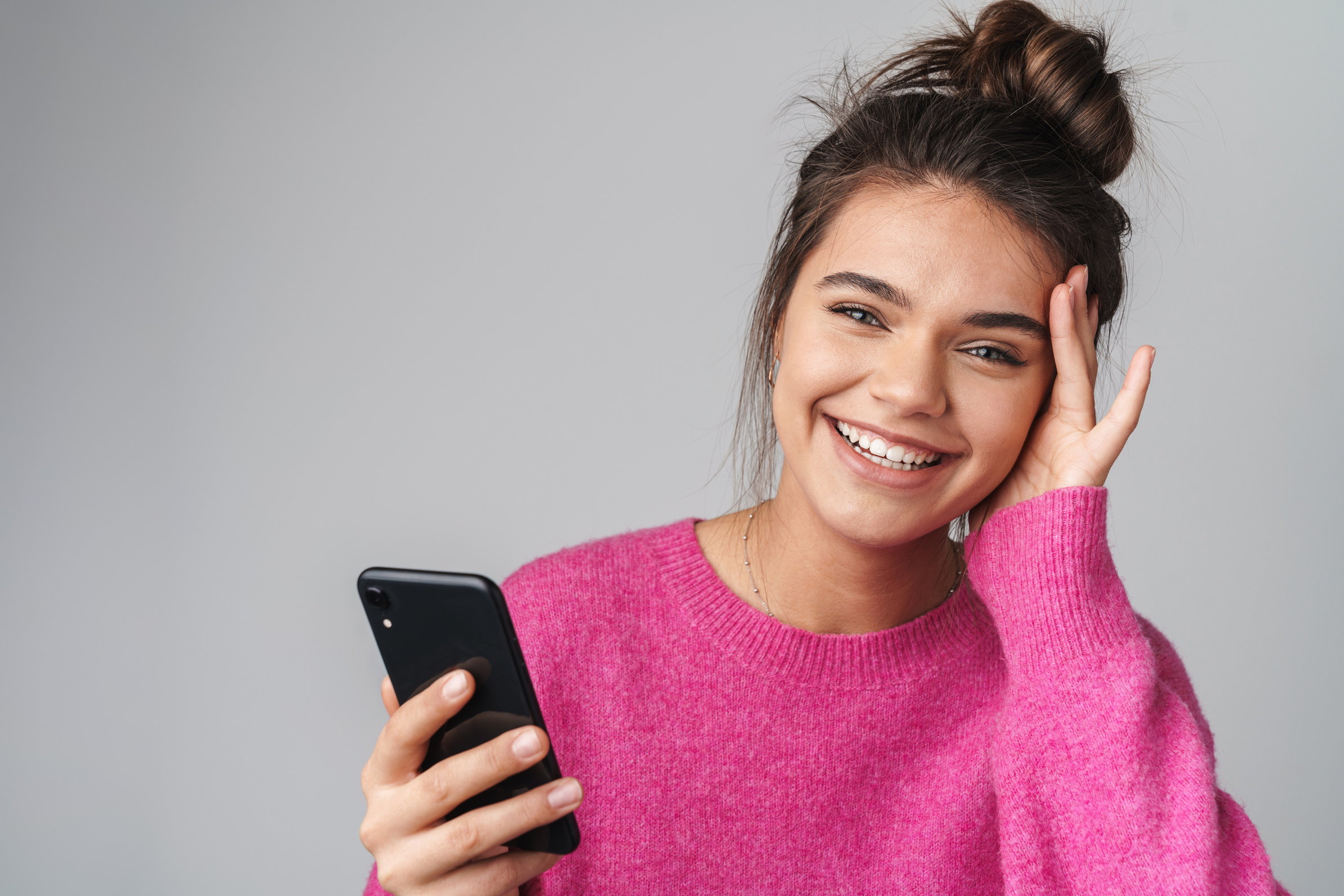 Woman Using Cellphone and Smiling