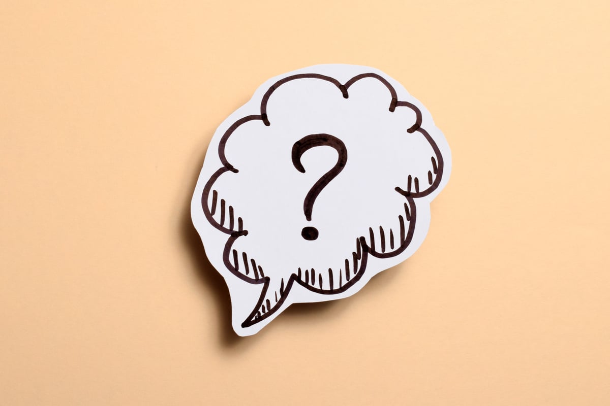 drawn question mark over beige background